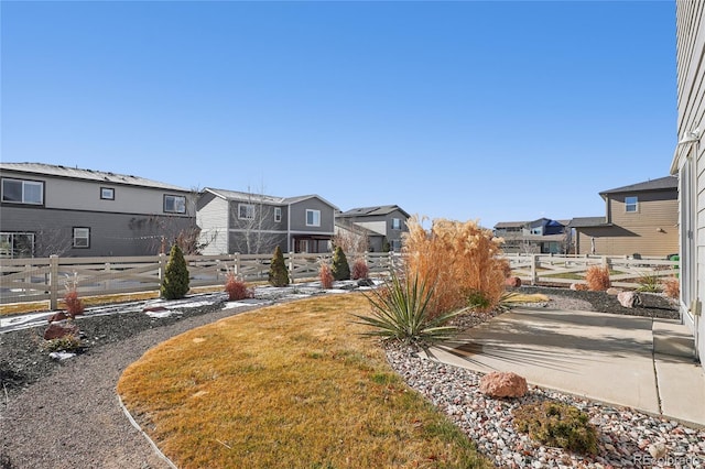 view of yard with a residential view and fence