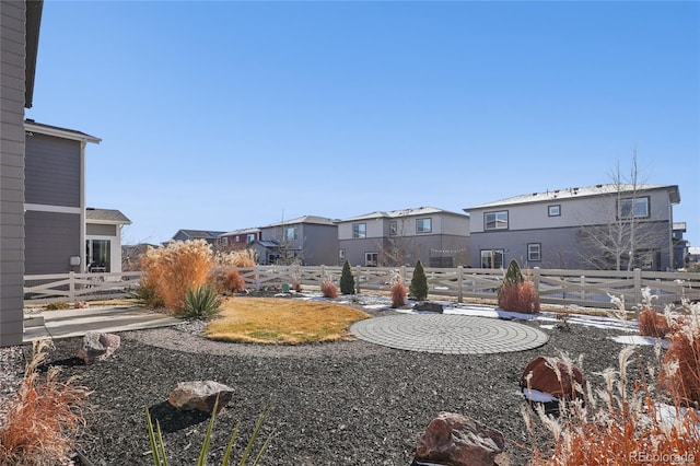 view of yard with a residential view and fence