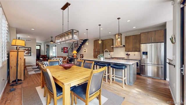 1426 S Pearl St, Denver, CO 80210 - dining area with light wood-style flooring, stairs, and recessed lighting