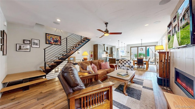 1426 S Pearl St, Denver, CO 80210 - living area with stairs, light wood finished floors, ceiling fan, recessed lighting, and a tiled fireplace
