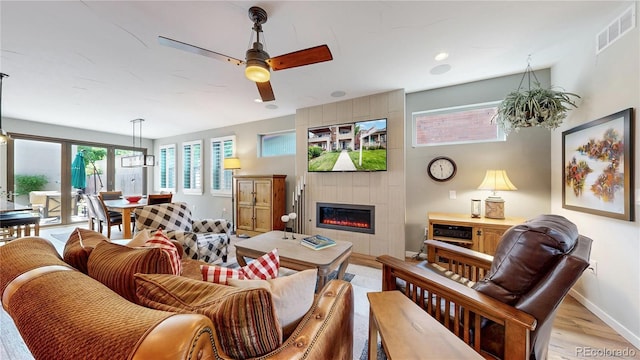 1426 S Pearl St, Denver, CO 80210 - living room featuring light wood finished floors, ceiling fan, and a tile fireplace