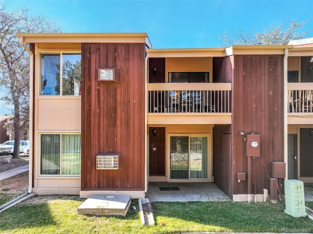 back of property with a balcony