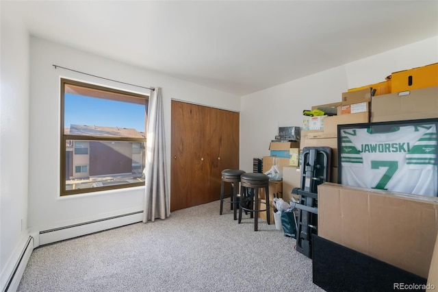 carpeted office space featuring a baseboard heating unit