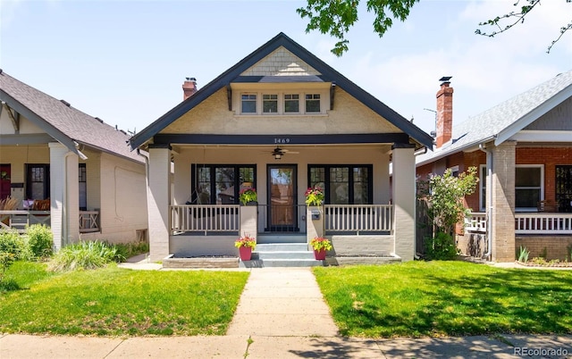 view of front facade featuring a porch, a front yard, and a chimney
