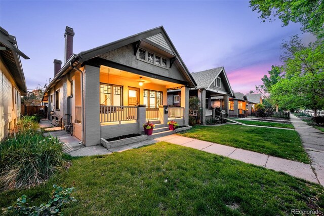 view of front of home featuring covered porch and a chimney