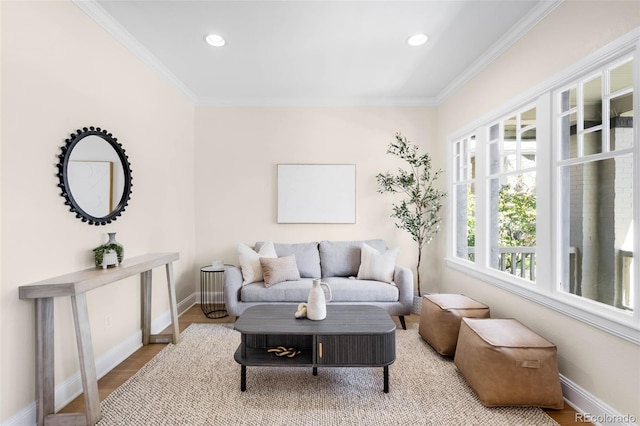 living room featuring crown molding, baseboards, recessed lighting, and wood finished floors