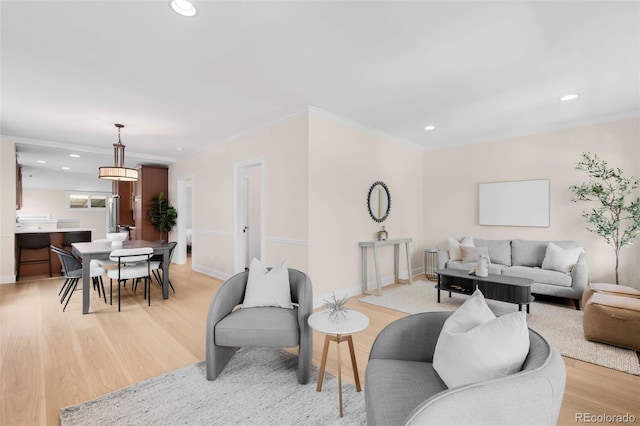 living area with light wood-style flooring, recessed lighting, ornamental molding, and baseboards