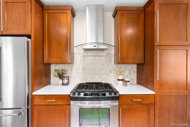 kitchen featuring appliances with stainless steel finishes, wall chimney range hood, backsplash, light countertops, and brown cabinetry
