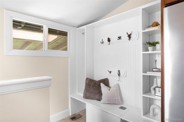 mudroom featuring vaulted ceiling
