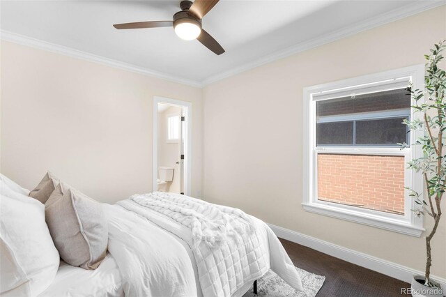 carpeted bedroom featuring crown molding, baseboards, ensuite bath, and ceiling fan