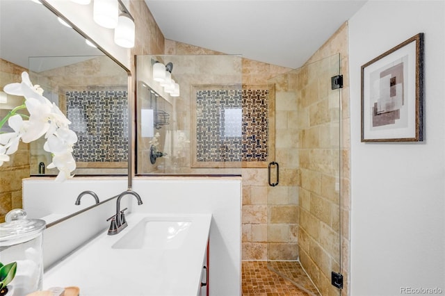 bathroom with lofted ceiling, a shower stall, and vanity