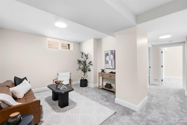 sitting room featuring carpet flooring and baseboards