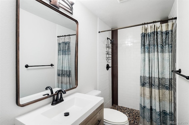 full bathroom with toilet, a shower stall, and vanity