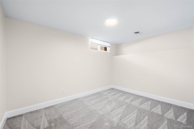 spare room with carpet and baseboards