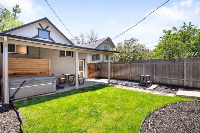 back of house with a patio area and brick siding