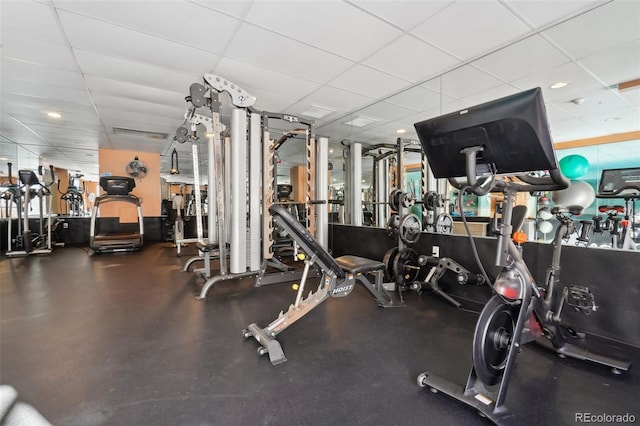 gym with a paneled ceiling