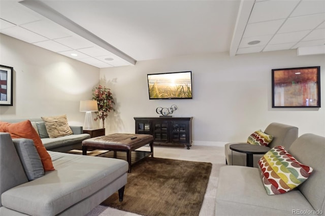 carpeted living room featuring a paneled ceiling