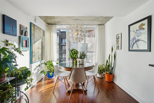 dining space featuring an inviting chandelier and hardwood / wood-style floors