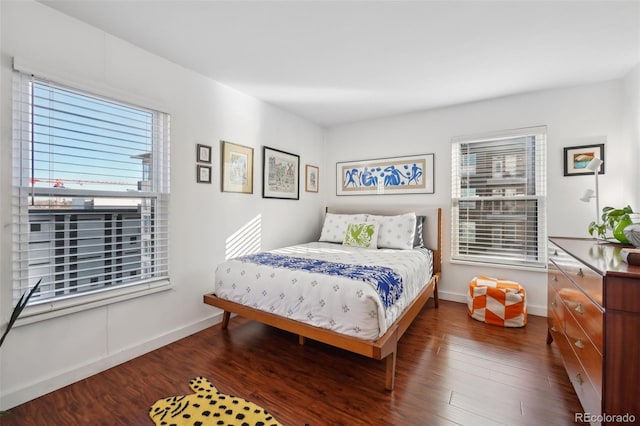 bedroom featuring dark hardwood / wood-style flooring and multiple windows