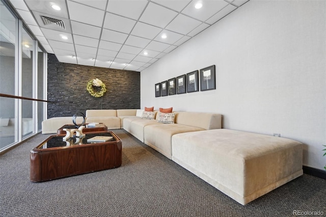 carpeted living room with a paneled ceiling