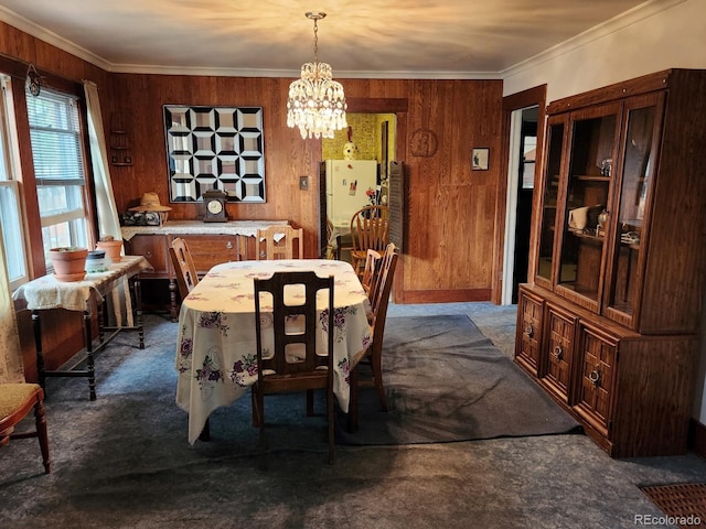 3036 W Clyde Pl, Denver, CO 80211 - dining room with dark carpet, a chandelier, crown molding, and wooden walls