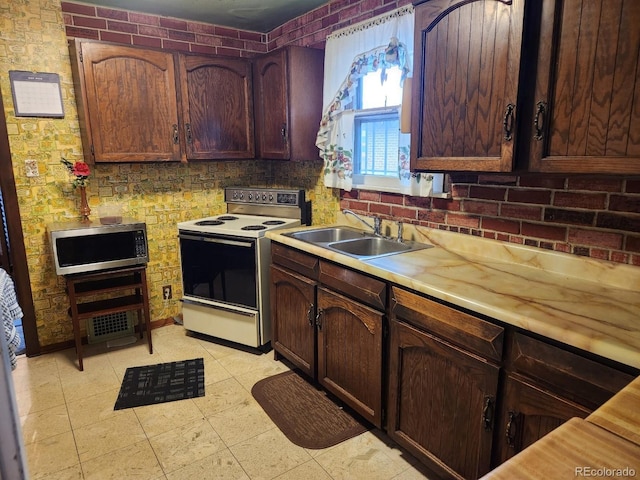 3036 W Clyde Pl, Denver, CO 80211 - kitchen featuring white electric range, stainless steel microwave, light countertops, and tasteful backsplash