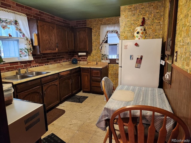 3036 W Clyde Pl, Denver, CO 80211 - kitchen featuring freestanding refrigerator, light countertops, dark brown cabinetry, and backsplash