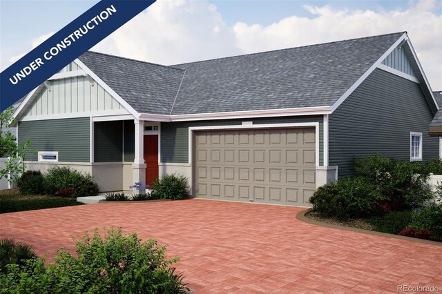 view of front facade featuring decorative driveway, a garage, board and batten siding, and a shingled roof