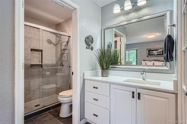 3752 S Helena Way, Aurora, CO 80013 - bathroom featuring a textured wall, a textured ceiling, vanity, a stall shower, and tile patterned flooring