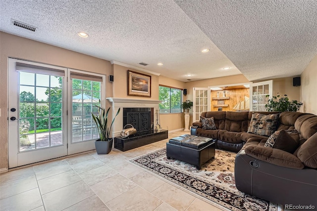 3752 S Helena Way, Aurora, CO 80013 - tiled living area with a textured ceiling, recessed lighting, and a tile fireplace