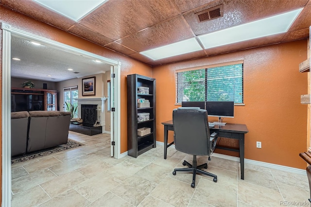 3752 S Helena Way, Aurora, CO 80013 - home office with a fireplace with raised hearth, light stone finish floors, and recessed lighting