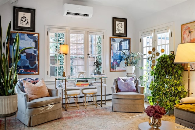 sitting room with an AC wall unit, a baseboard heating unit, and lofted ceiling