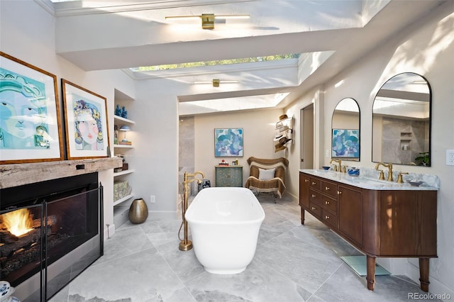 bathroom with a washtub, vanity, and built in shelves