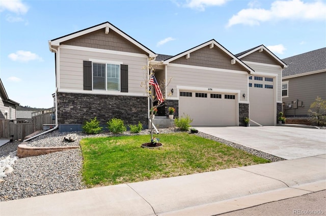 craftsman inspired home featuring a garage and a front lawn