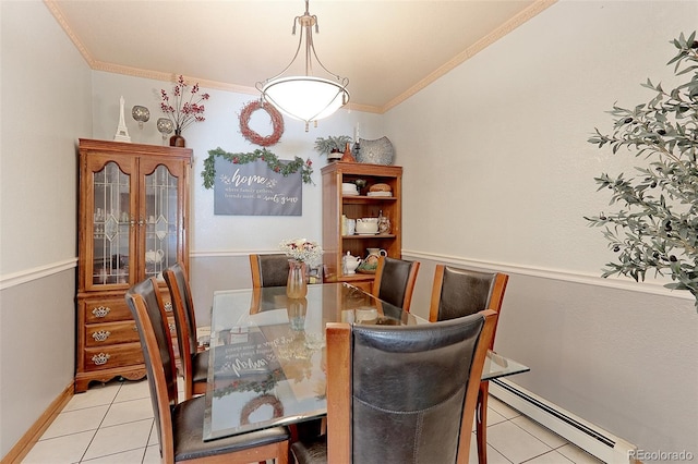 dining room featuring a baseboard heating unit, ornamental molding, and light tile patterned floors