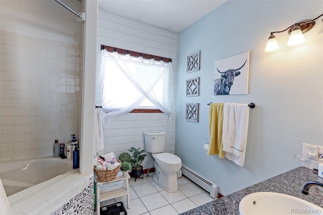 bathroom featuring toilet, vanity, a baseboard heating unit, and tile patterned floors