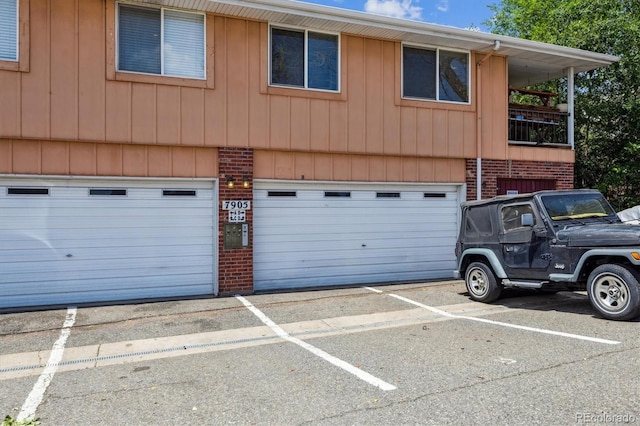 7905 Lowell Blvd Unit B, Westminster, CO 80030 - view of front of property featuring brick siding, an attached garage, and uncovered parking