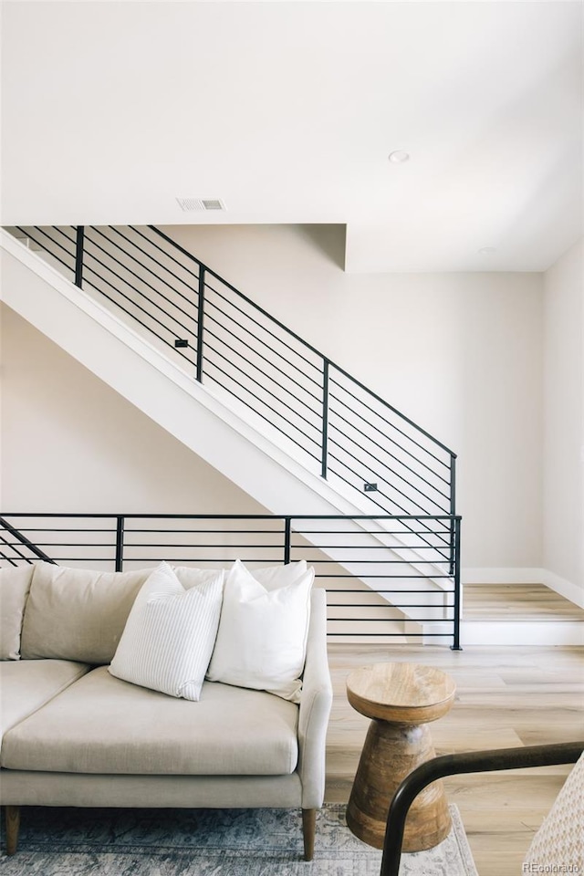 interior space with visible vents, baseboards, and wood finished floors