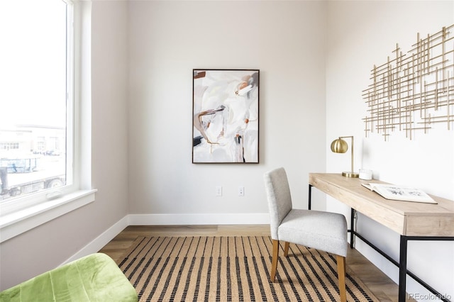 office space with baseboards and wood finished floors