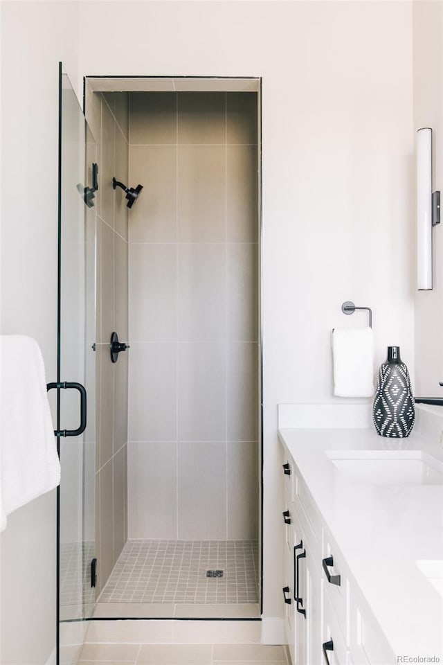 bathroom featuring a stall shower and vanity