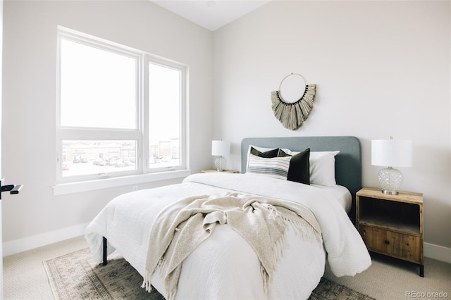 carpeted bedroom featuring baseboards