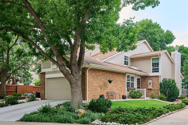 traditional-style house with fence, brick siding, driveway, and a chimney