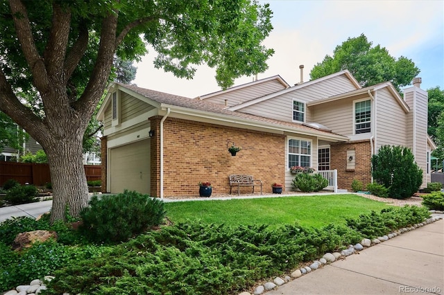 view of front facade featuring a front lawn, fence, an attached garage, brick siding, and a chimney