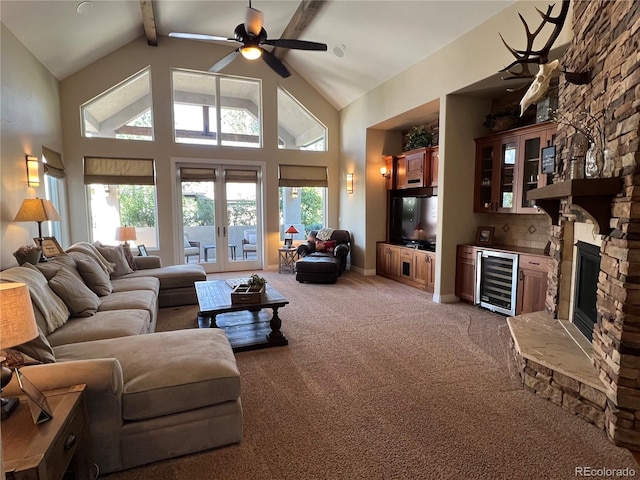 carpeted living room with wine cooler, beam ceiling, high vaulted ceiling, and ceiling fan