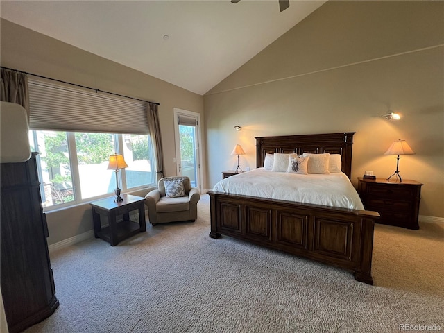 carpeted bedroom with high vaulted ceiling