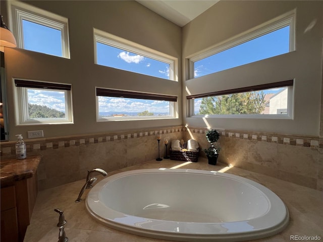 bathroom with a wealth of natural light and tiled tub