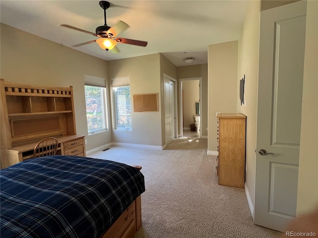 carpeted bedroom featuring connected bathroom and ceiling fan