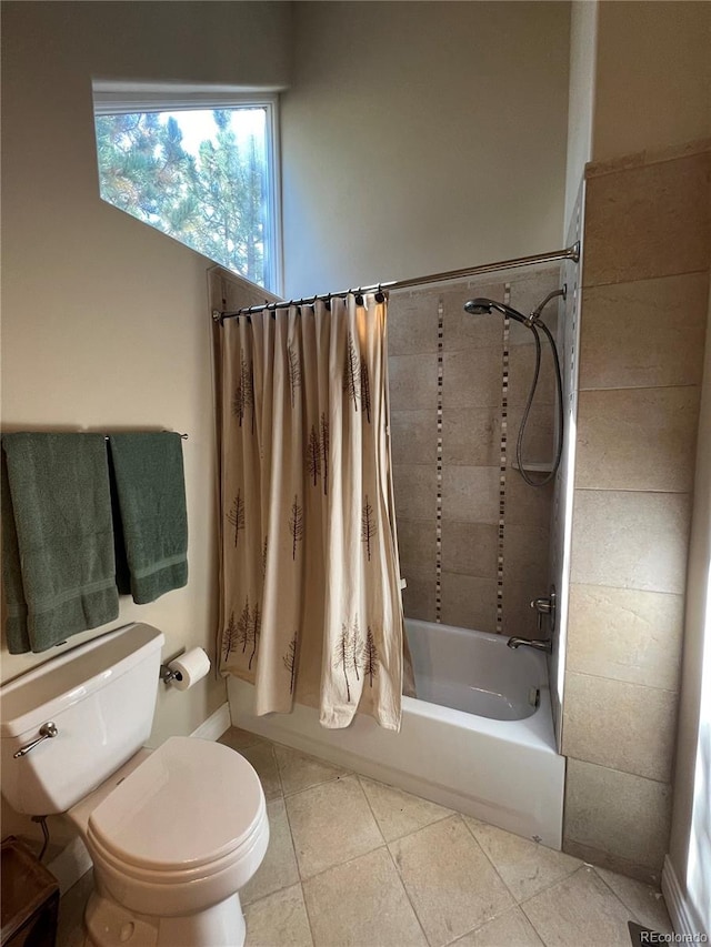 bathroom featuring tile patterned floors, shower / bath combo with shower curtain, and toilet