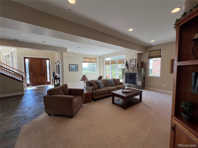 living room featuring carpet floors and a healthy amount of sunlight