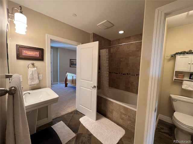 bathroom featuring toilet and shower / bath combination with curtain